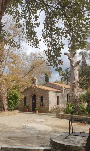 The traditional stone Agia Paraskevi chapel nestled among mature trees near our self-catering accommodation Skiathos.